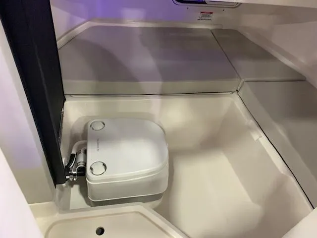 Slide: The Image of 2024 Sea Ray SDX 250 boat interior with compact toilet. - 9