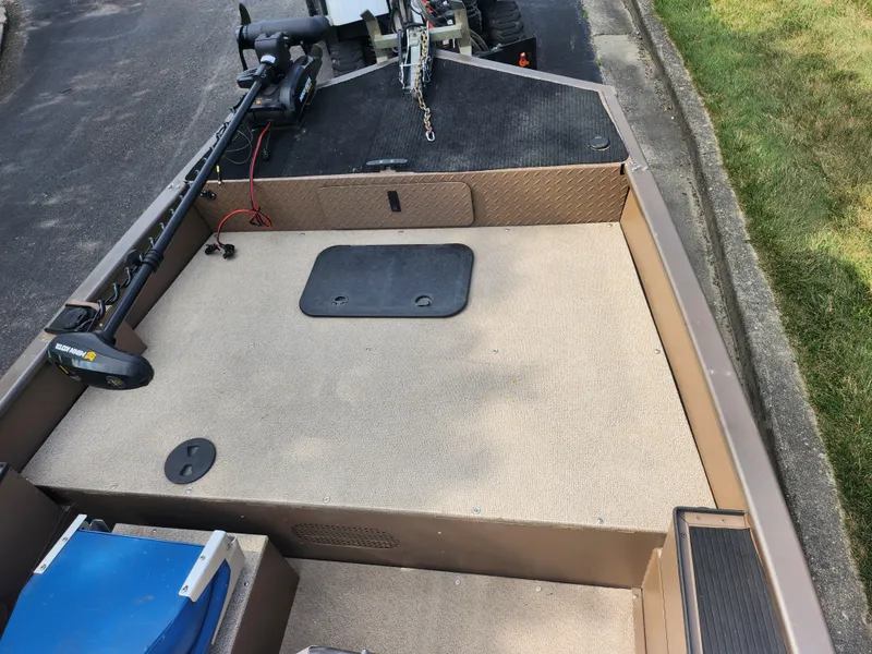 Slide: The Image of 2015 Smoker Craft Sportsman Pro 1866 boat deck with storage compartments and trolling motor. - 12