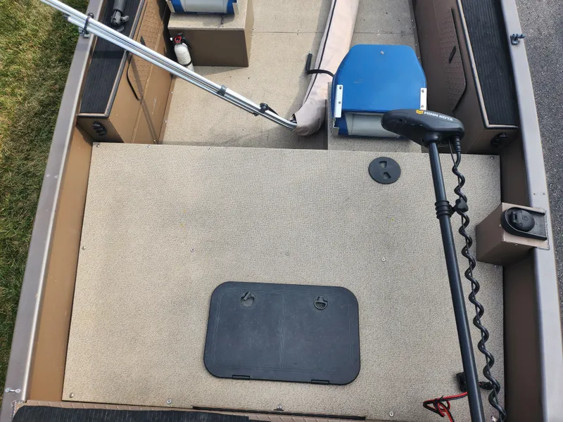 Slide: The Image of 2015 Smoker Craft Sportsman Pro 1866 boat interior with fishing gear and storage compartments. - 16