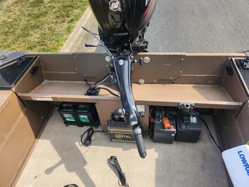 Slide: The Image of 2015 Smoker Craft Sportsman Pro 1866 boat interior with motor and battery setup. - 21