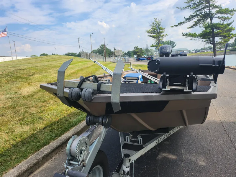 Slide: The Image of 2015 Smoker Craft Sportsman Pro 1866 boat on trailer near a lake. - 7