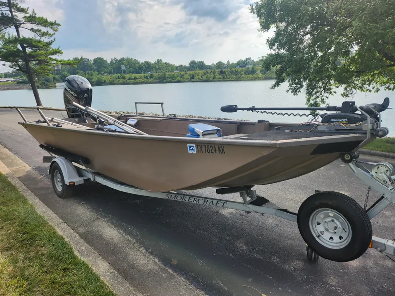 Slide: The Image of 2015 Smoker Craft Sportsman Pro 1866 boat on a trailer by a lake. - 9