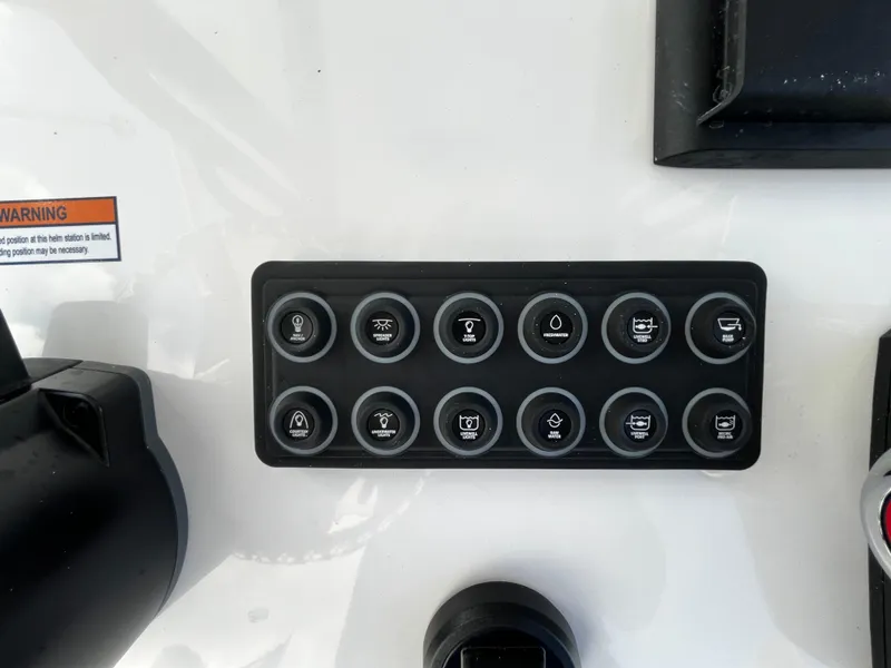 Slide: The Image of Control panel of a 2024 Sportsman Masters 247 Bay Boat with various function buttons. - 15