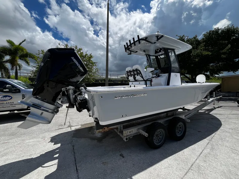 Slide: The Image of 2024 Sportsman Masters 247 Bay Boat on trailer under cloudy sky. - 2