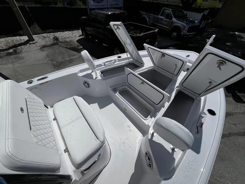 Slide: The Image of 2024 Sportsman Masters 247 Bay Boat with open storage compartments and seating. - 22
