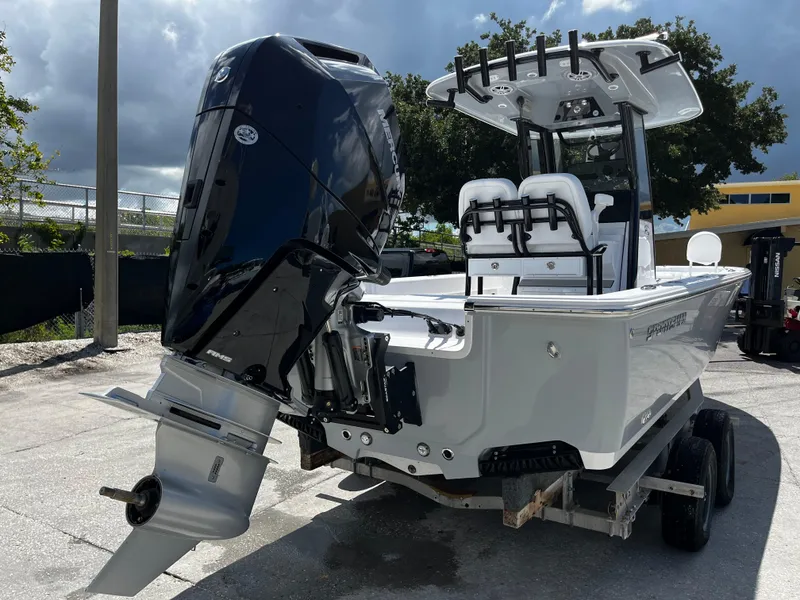 Slide: The Image of 2024 Sportsman Masters 247 Bay Boat on trailer, rear view with outboard motor. - 3