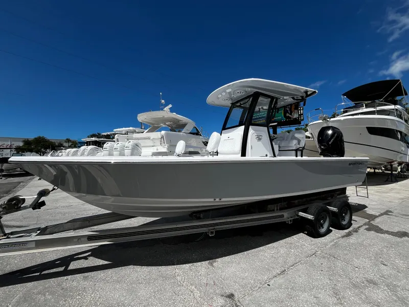 Slide: The Image of 2024 Sportsman Masters 247 Bay Boat on a trailer, docked at a marina. - 6