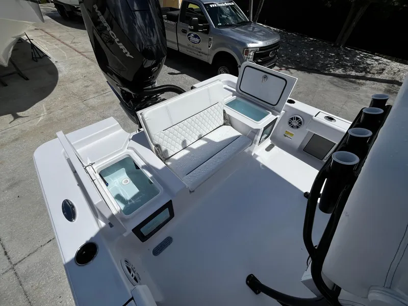 Slide: The Image of 2024 Sportsman Masters 247 Bay Boat with open storage compartments and seating. - 9