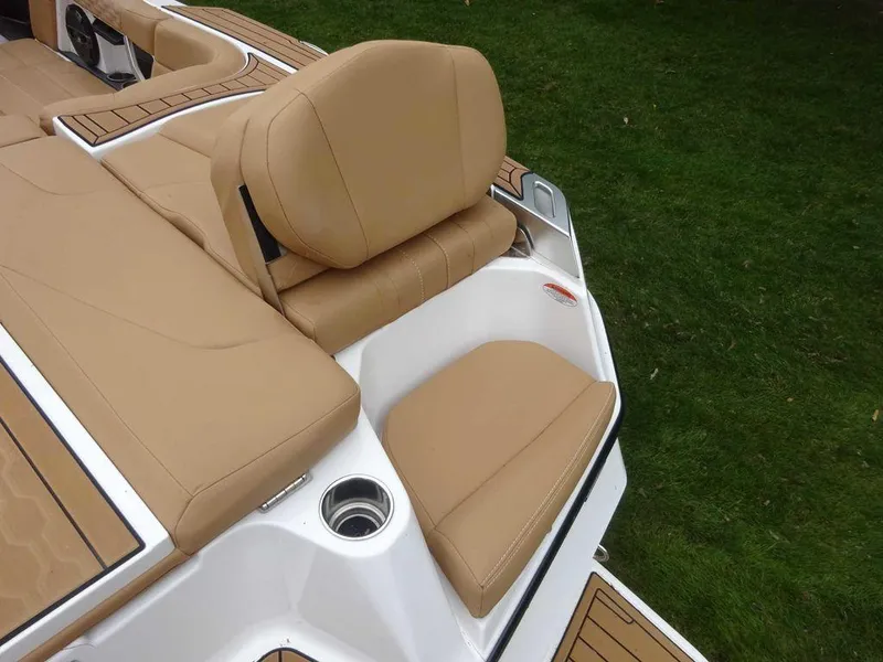 Slide: The Image of 2022 MasterCraft XT23 boat with tan leather seating and cup holder. - 17