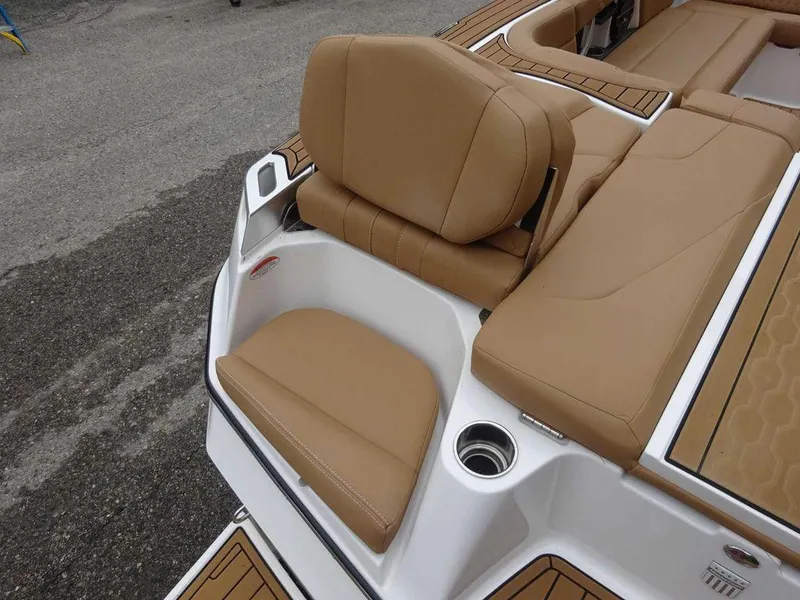 Slide: The Image of 2022 MasterCraft XT23 boat with tan leather seating and cup holder. - 18
