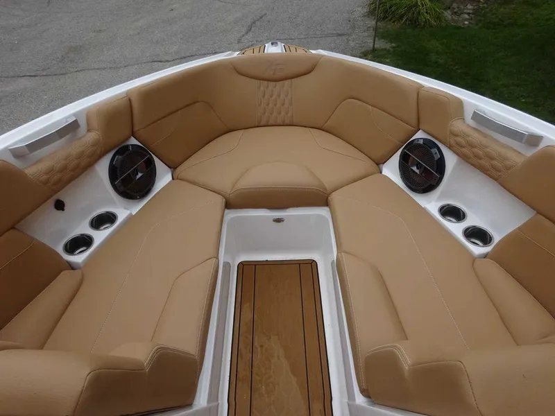 Slide: The Image of 2022 MasterCraft XT23 boat with tan leather seating and built-in speakers. - 20