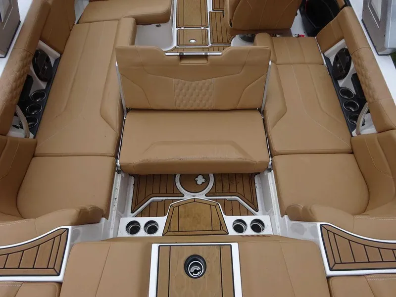Slide: The Image of 2022 MasterCraft XT23 boat interior with tan leather seating and wood accents. - 8