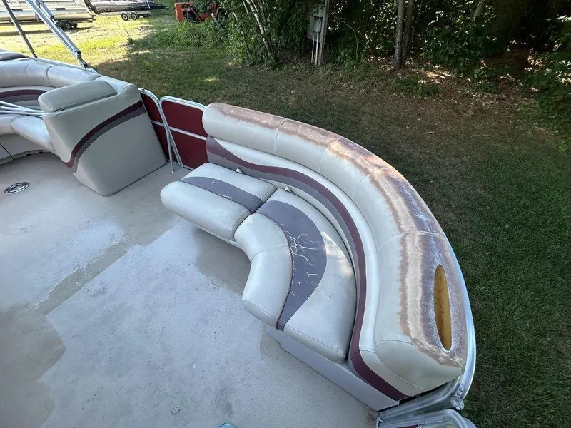 Slide: The Image of 2012 South Bay 518 CR pontoon boat with worn seating upholstery. - 7