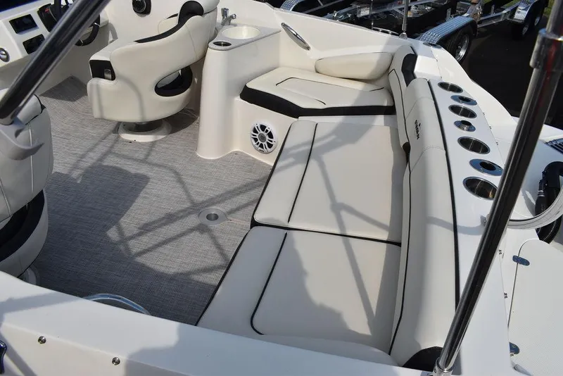 Slide: The Image of 2024 Stingray 201DC boat interior with beige seating and modern amenities. - 10