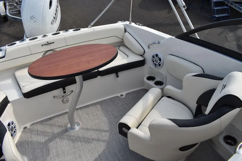 Slide: The Image of 2024 Stingray 201DC boat interior with seating and table. - 20