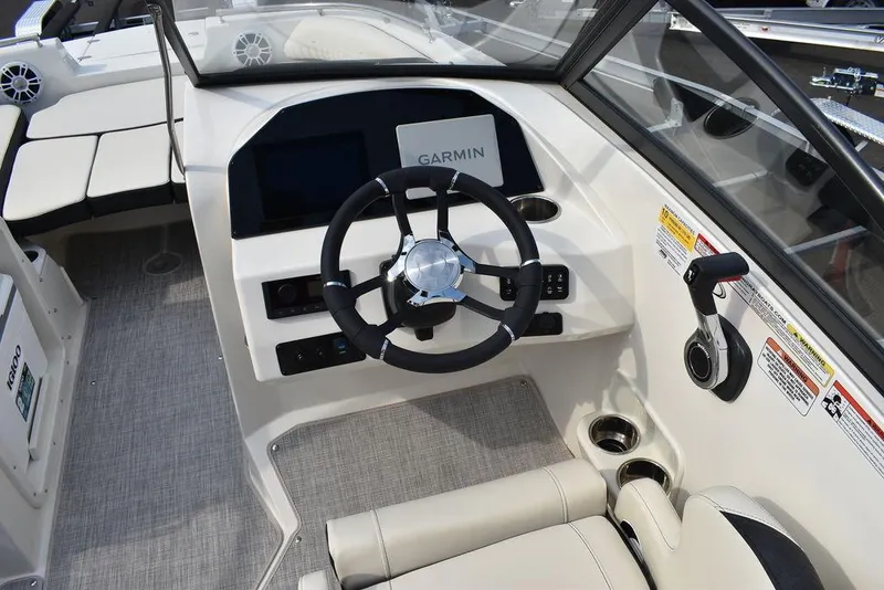Slide: The Image of 2024 Stingray 201DC boat cockpit with Garmin navigation system and modern steering wheel. - 25