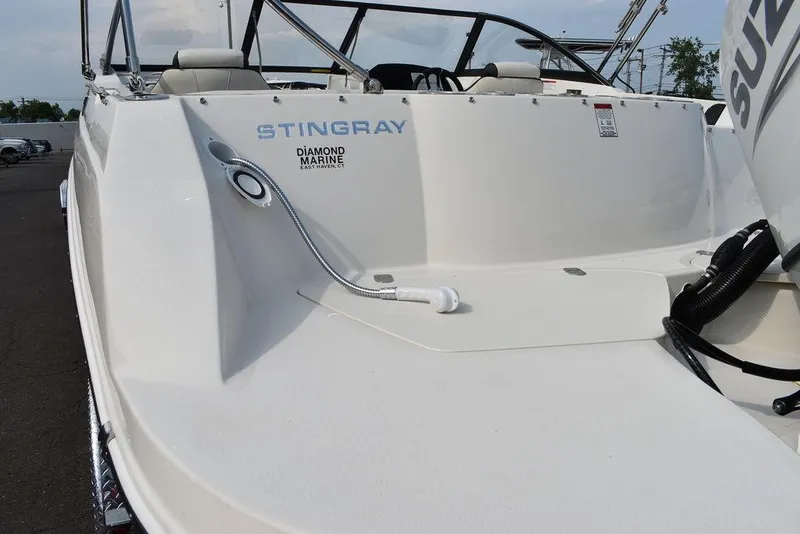 Slide: The Image of 2024 Stingray 201DC boat rear deck with Diamond Marine branding. - 26