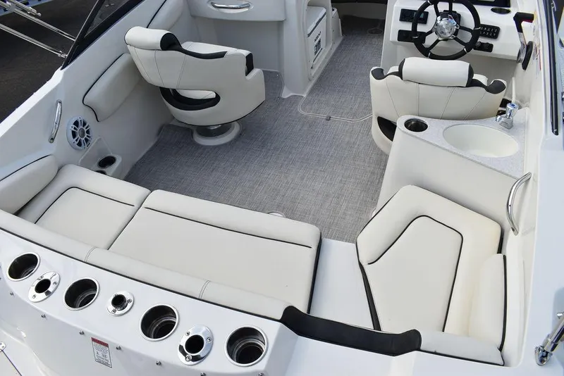 Slide: The Image of 2024 Stingray 201DC boat interior with white seating and modern dashboard. - 27