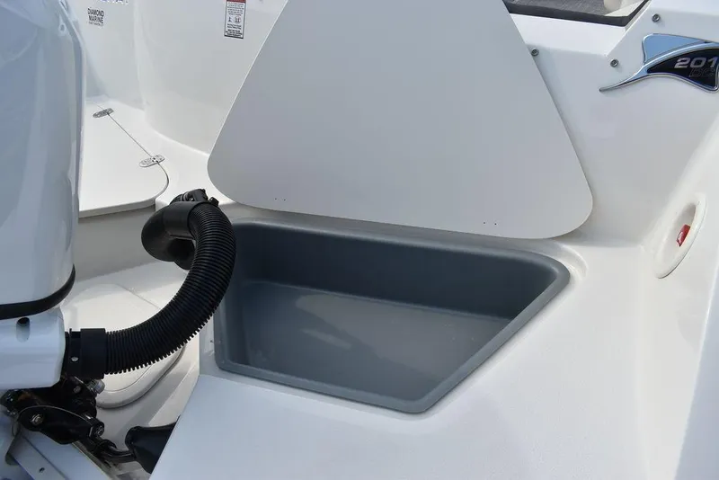 Slide: The Image of 2024 Stingray 201DC boat storage compartment and engine detail. - 28