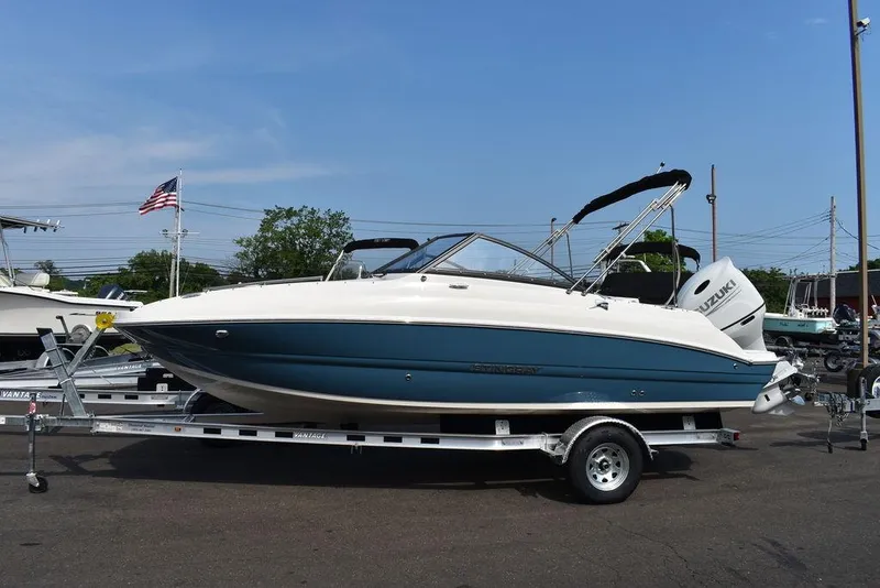 Slide: The Image of 2024 Stingray 201DC boat on a trailer in a parking lot. - 3