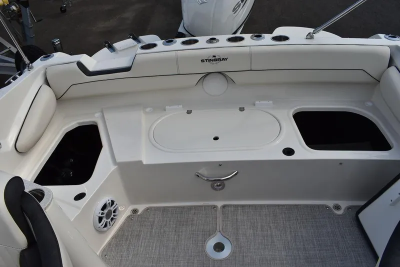 Slide: The Image of 2024 Stingray 201DC boat interior with storage compartments and seating. - 34