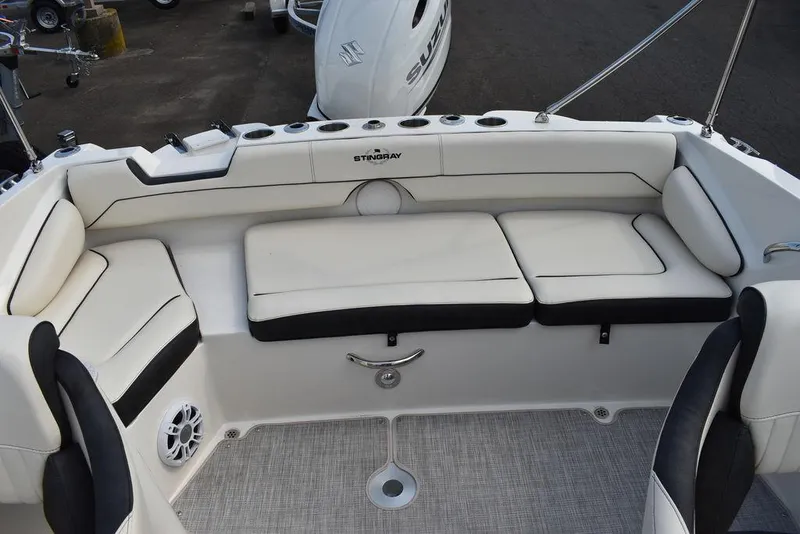 Slide: The Image of 2024 Stingray 201DC boat interior with white cushioned seating. - 35