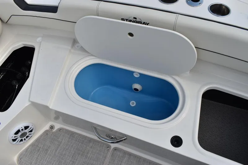 Slide: The Image of Stingray 201DC 2024 boat with open storage compartment and blue interior. - 36