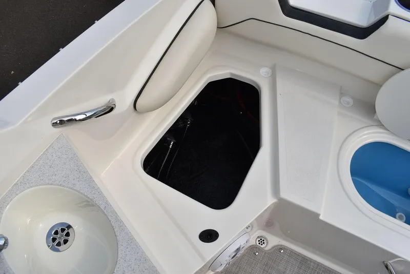 Slide: The Image of 2024 Stingray 201DC boat interior storage compartment and seating area. - 37