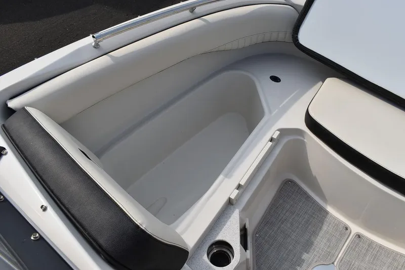 Slide: The Image of 2024 Stingray 201DC boat interior seating and storage compartment. - 47