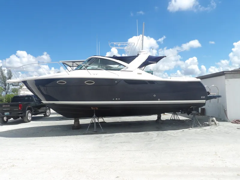 Slide: The Image of 2012 Tiara Yachts 3100 Coronet on dry dock under a clear blue sky. - 0