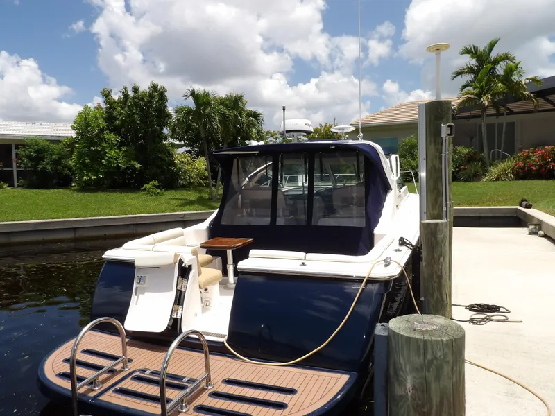 Slide: The Image of 2012 Tiara Yachts 3100 Coronet docked, rear view with swim platform and ladder. - 12