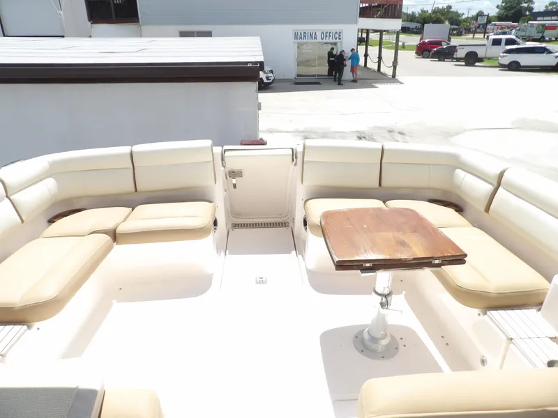 Slide: The Image of 2012 Tiara Yachts 3100 Coronet boat with spacious seating and wooden table. - 13