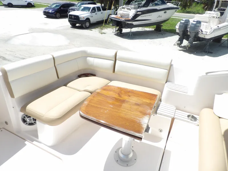 Slide: The Image of 2012 Tiara Yachts 3100 Coronet boat interior with seating and wooden table. - 15