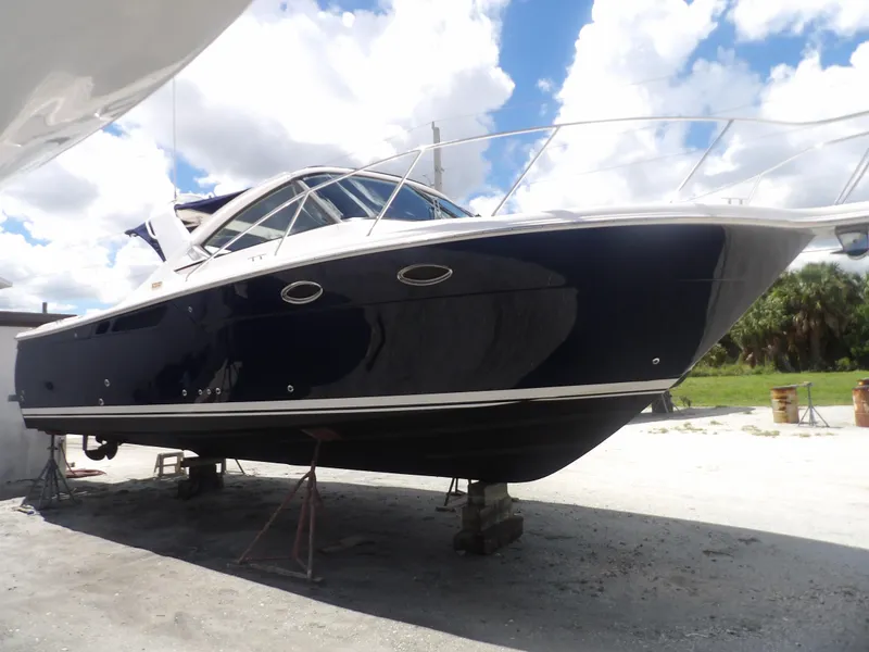 Slide: The Image of 2012 Tiara Yachts 3100 Coronet on dry dock under a partly cloudy sky. - 2