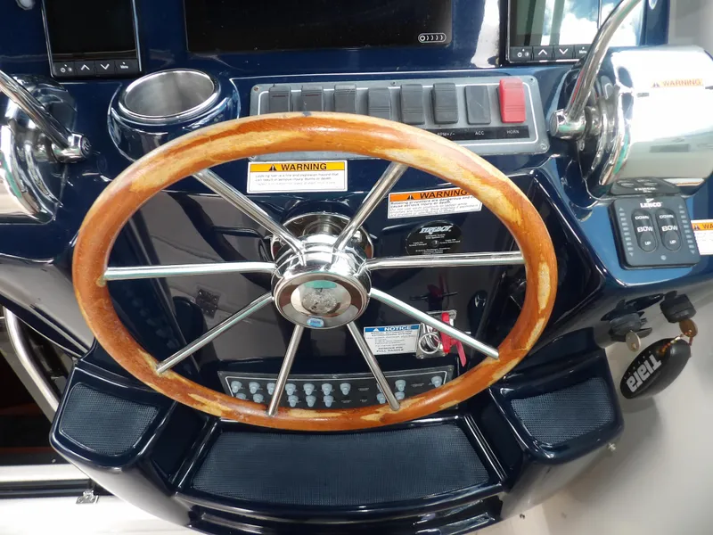 Slide: The Image of Steering wheel and control panel of a 2012 Tiara Yachts 3100 Coronet. - 42