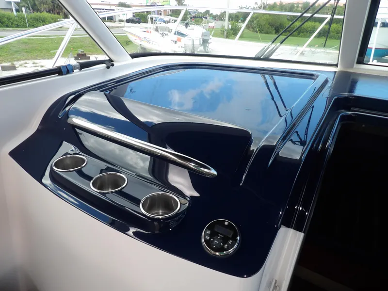 Slide: The Image of 2012 Tiara Yachts 3100 Coronet dashboard with cup holders and sleek design. - 43