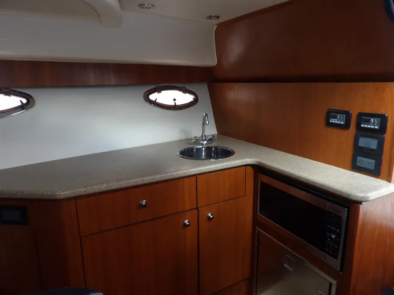 Slide: The Image of 2012 Tiara Yachts 3100 Coronet interior kitchen with sink and microwave. - 45