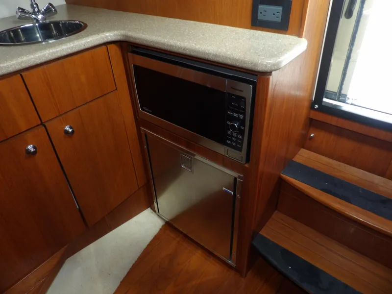 Slide: The Image of 2012 Tiara Yachts 3100 Coronet interior kitchen with microwave and sink - 46