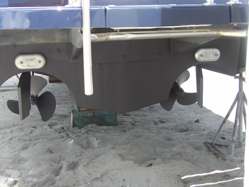 Slide: The Image of 2012 Tiara Yachts 3100 Coronet propellers and hull on sandy ground. - 8