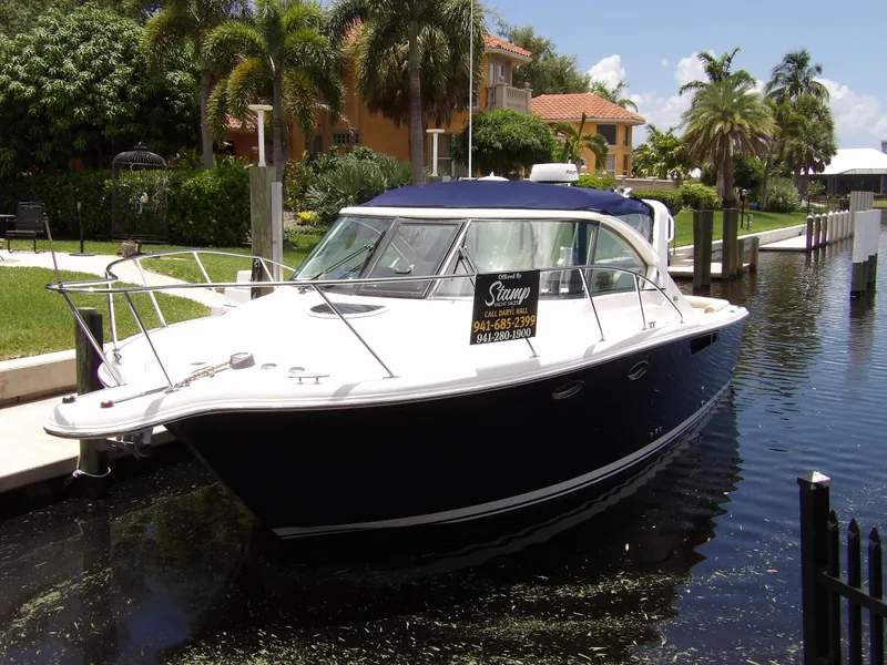 Slide: The Image of 2012 Tiara Yachts 3100 Coronet docked in a sunny, tropical marina. - 9