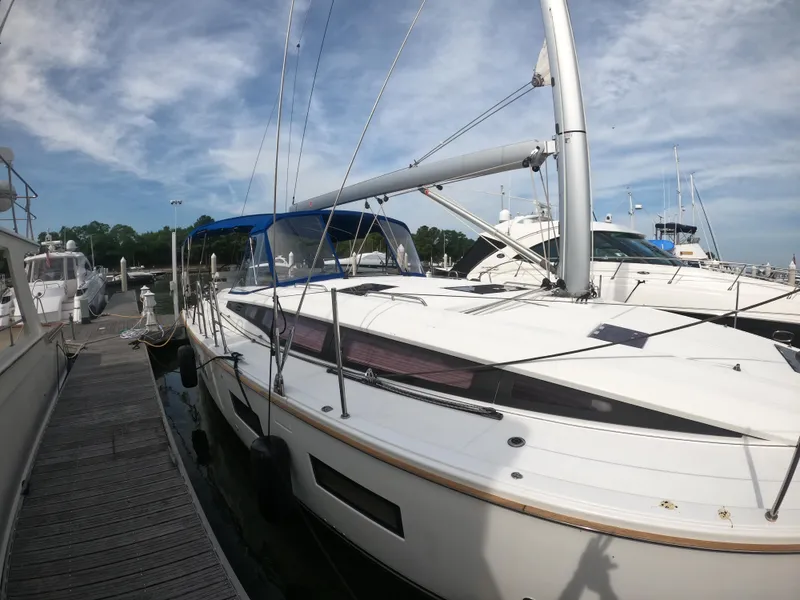 Slide: The Image of Jeanneau 54 sailboat, 2017 model, docked at marina under blue sky. - 13