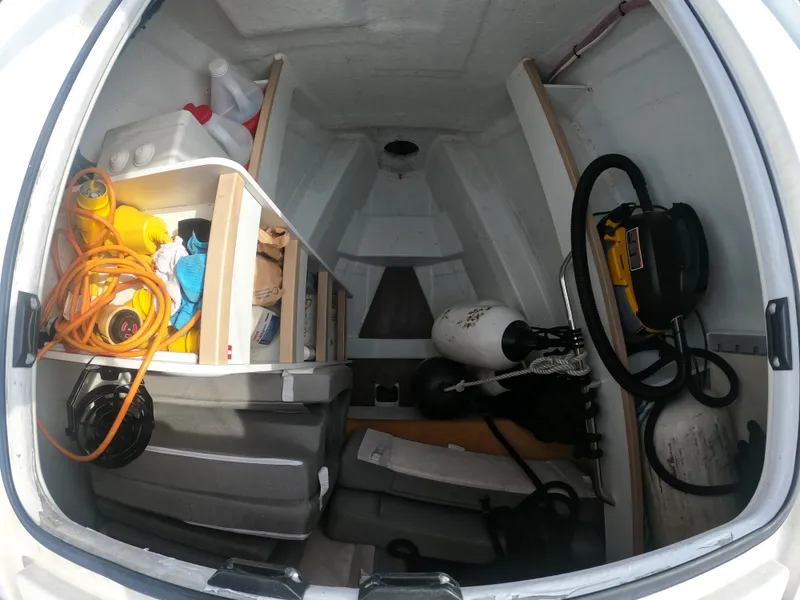 Slide: The Image of Storage compartment of a 2017 Jeanneau 54 sailboat with various equipment and supplies. - 15