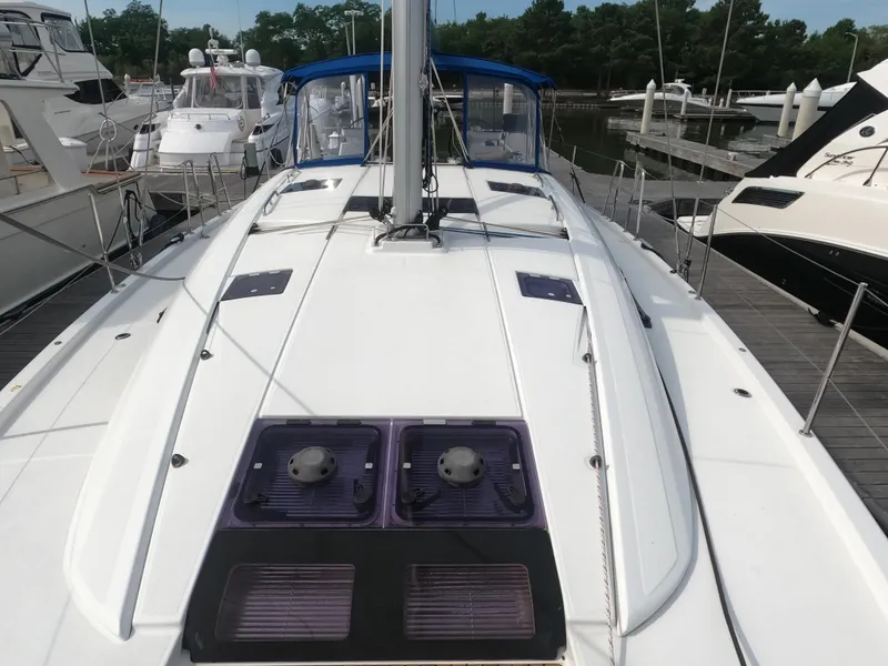 Slide: The Image of 2017 Jeanneau 54 sailboat docked at marina, view of deck and cockpit. - 16