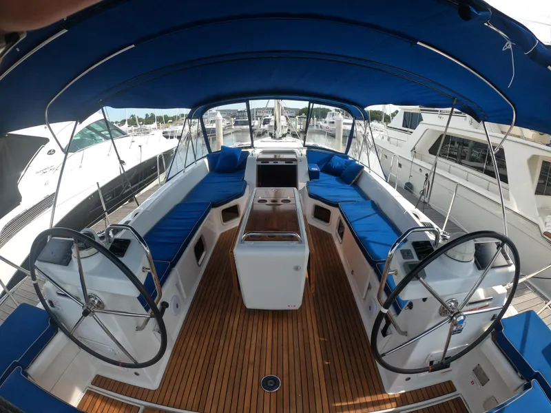 Slide: The Image of Cockpit of 2017 Jeanneau 54 sailboat with blue canopy and seating. - 24
