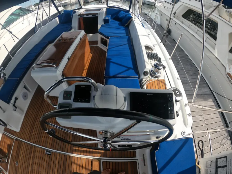Slide: The Image of Cockpit of 2017 Jeanneau 54 sailboat with blue cushions and modern navigation equipment. - 25