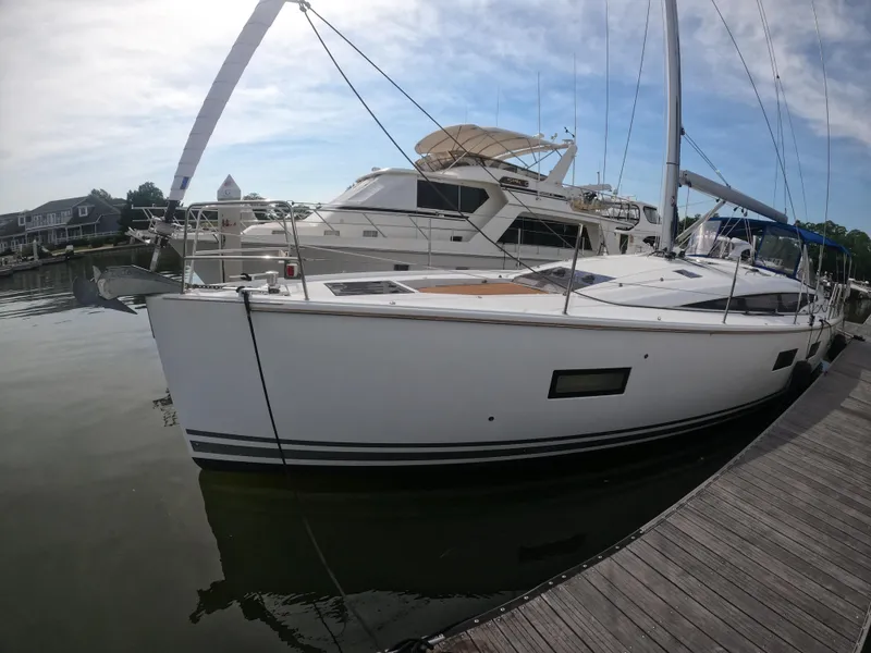 Slide: The Image of 2017 Jeanneau 54 sailboat docked at a marina. - 3