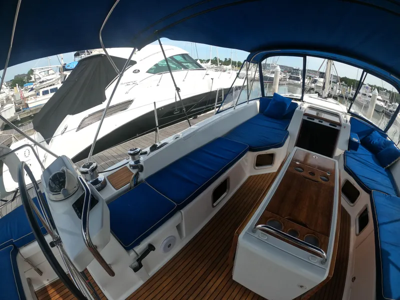 Slide: The Image of Interior view of 2017 Jeanneau 54 sailboat with blue seating and wooden flooring. - 30
