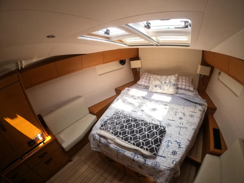 Slide: The Image of Cozy cabin interior of 2017 Jeanneau 54 yacht with skylight and double bed. - 37