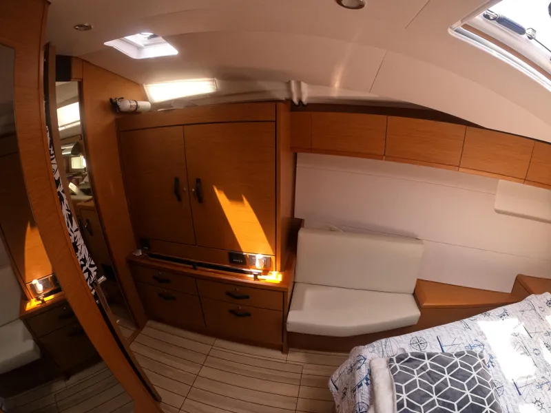 Slide: The Image of Interior of 2017 Jeanneau 54 yacht with wooden cabinetry and cozy seating area. - 38