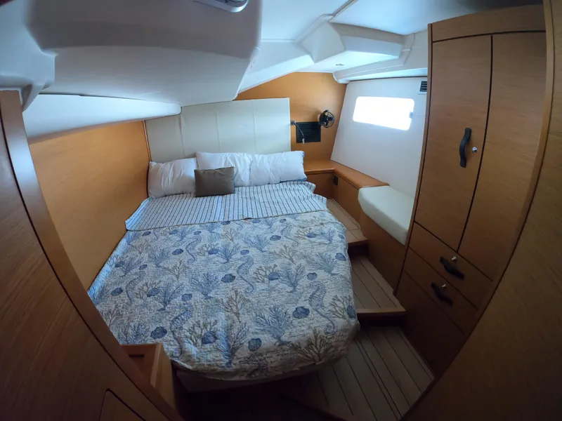 Slide: The Image of Cozy cabin interior of 2017 Jeanneau 54 yacht with bed and wooden furnishings. - 46